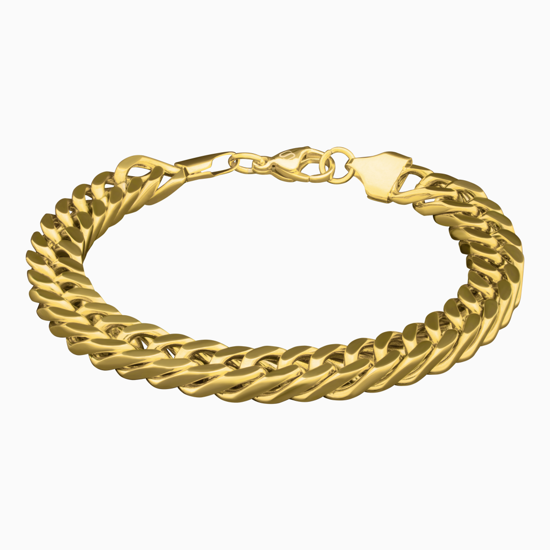 Cuban link-armband i guldfinish mot vit bakgrund – kraftfullt smycke med lyxig känsla.#en:color_gold,sv:farg_guld