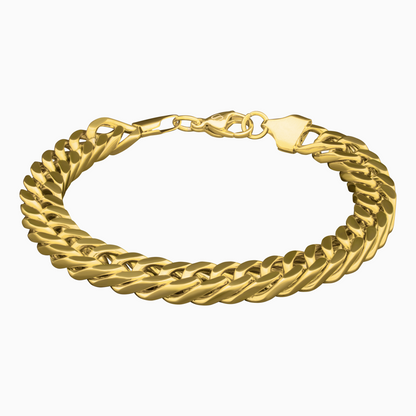Cuban link-armband i guldfinish mot vit bakgrund – kraftfullt smycke med lyxig känsla.